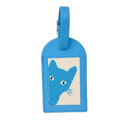 Blue needlepoint luggage tag with cat design