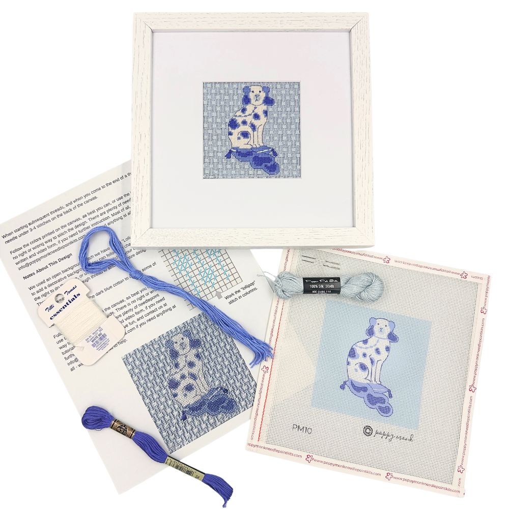 Needlepoint kit with a blue and white dog and a white frame
