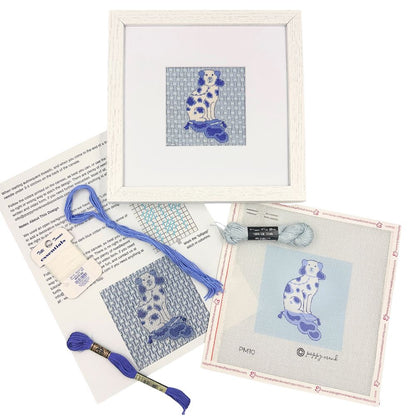 Needlepoint kit with a blue and white dog and a white frame