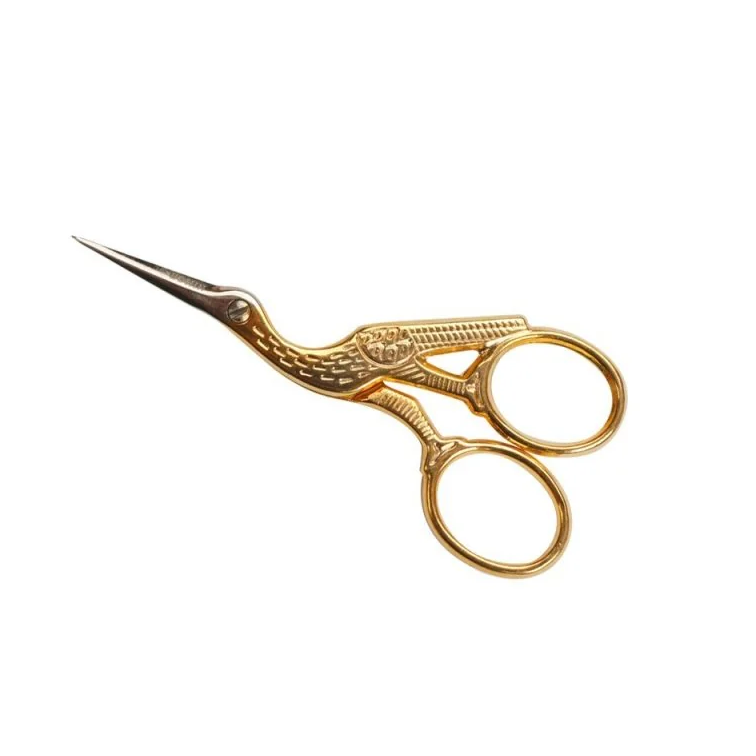 Gold embroidery scissors on a white background
