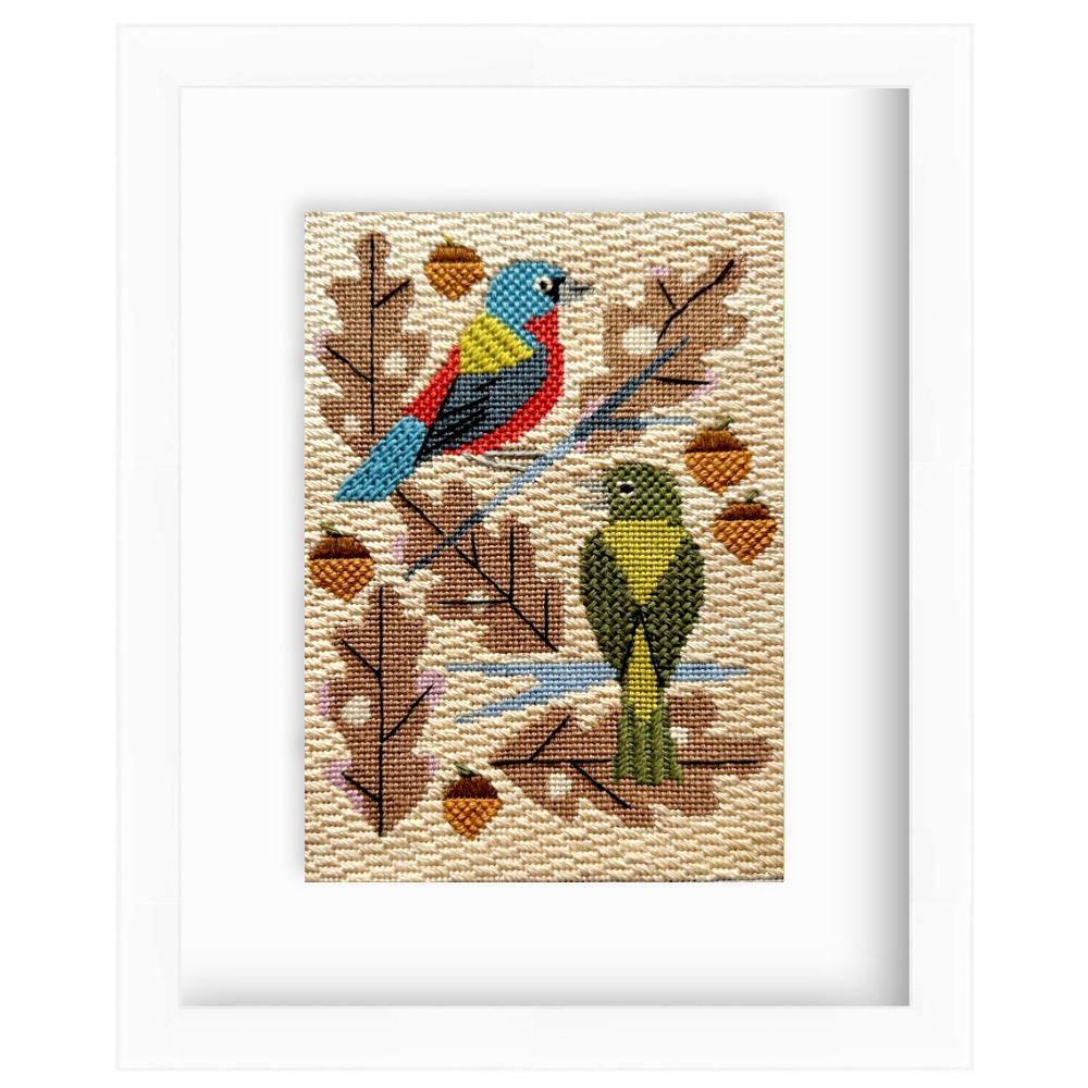 Needlepoint design of two birds on a branch with leaves and acorns.