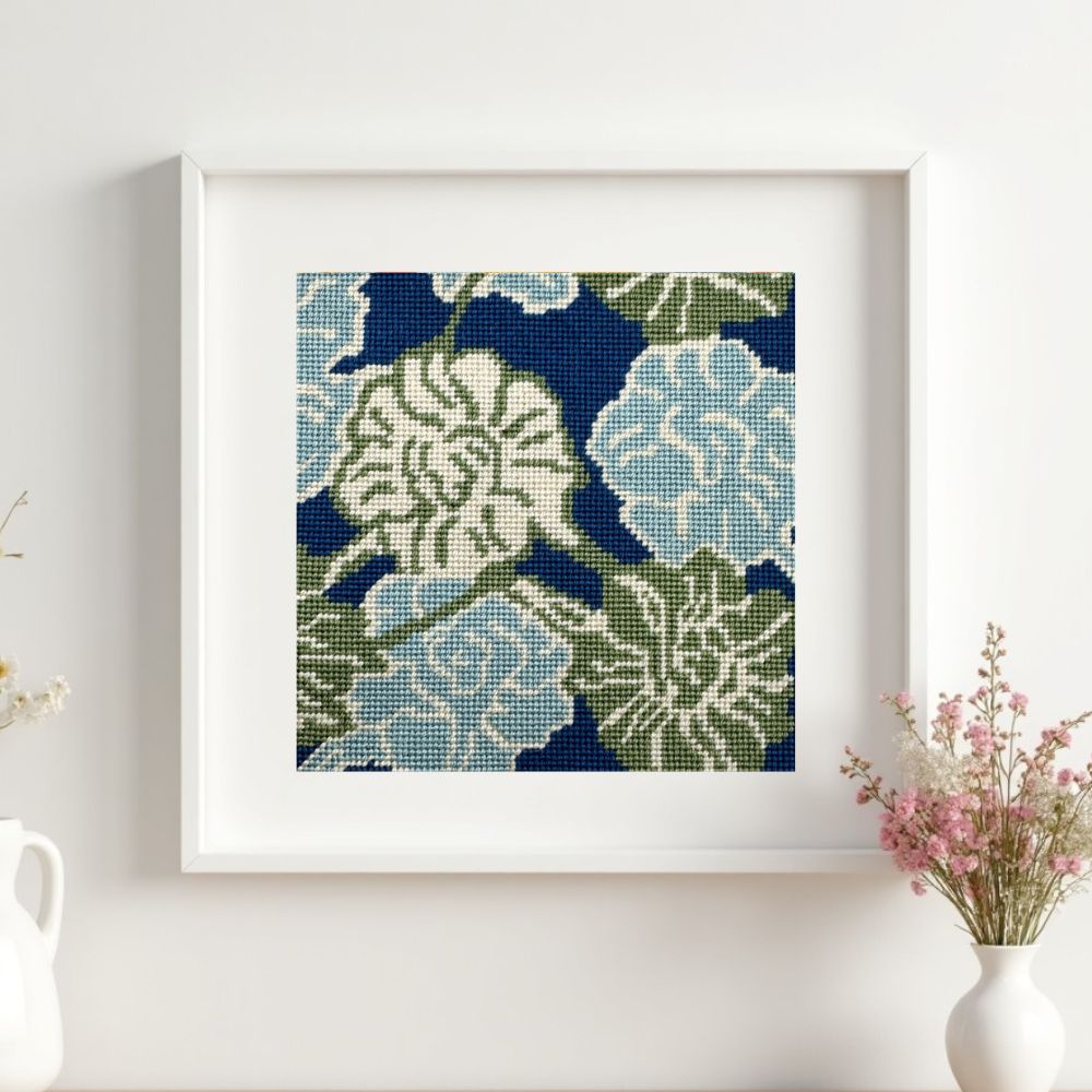 A needlepoint tapestry framed on a wall