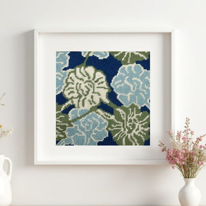 A needlepoint tapestry framed on a wall