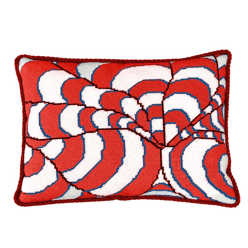 Decorative needlepoint pillow with red and white pattern on a white background