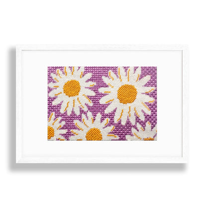 Framed needlepoint design with daisies