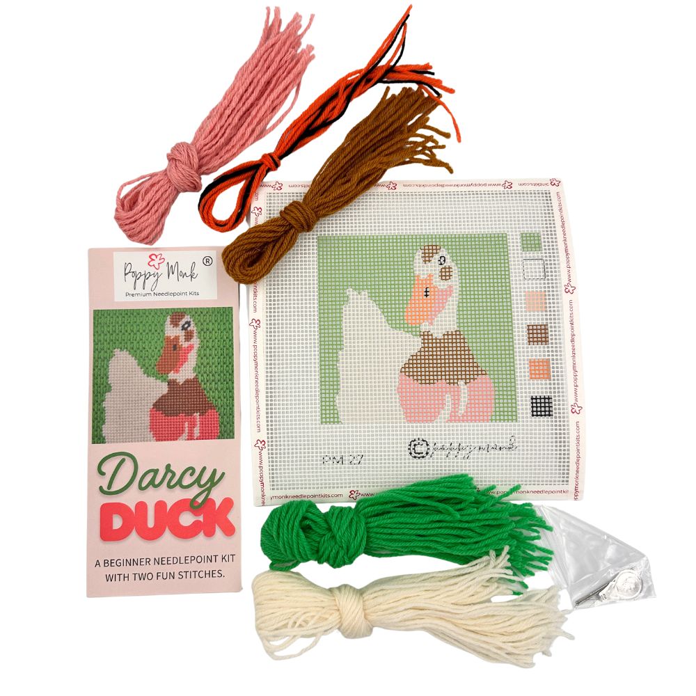 Needlepoint kit with thread colors and a pattern on a white background