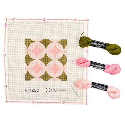 Geometric needlepoint design with threads in green and pinks
