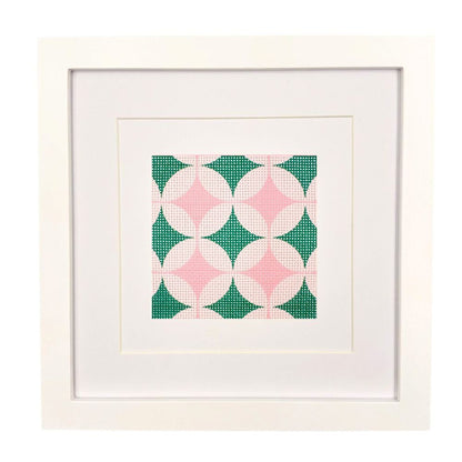 Geometric design needlepoint canvas ion steel green and pinks shown in a white frame