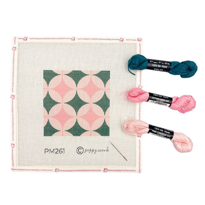 Geometric design needlepoint canvas ion steel green and pinks shown with three skeins of silk threads
