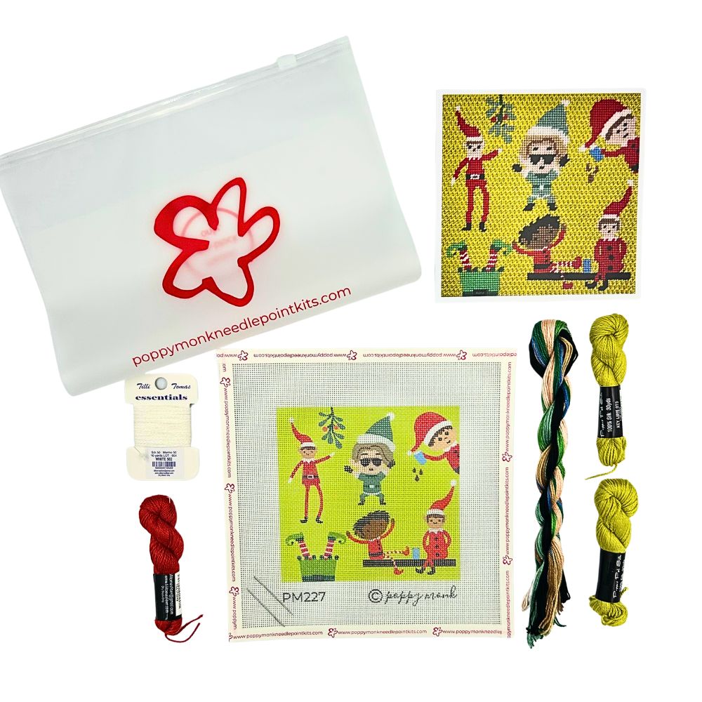 Poppy Monk Needlepoint Kits Christmas Elf canvas kit components laid out on a white background, including a white zippered pouch with a red paw print logo, a printed design card, a stitched sample, two skeins of red and yellow thread, and two skeins of multicolor embroidery thread.