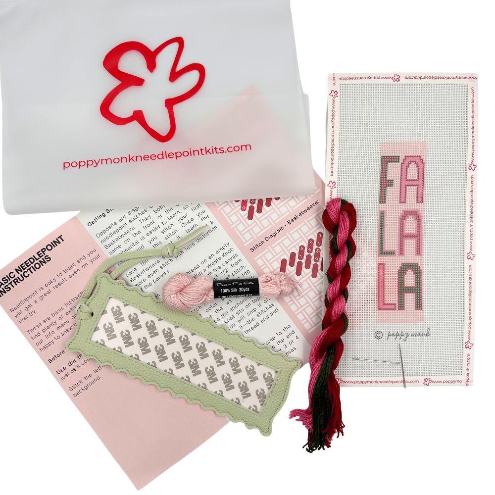 A needlepoint kit of a Fa La La design with threads and instructions