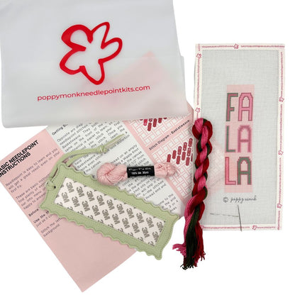 A needlepoint kit of a Fa La La design with threads and instructions