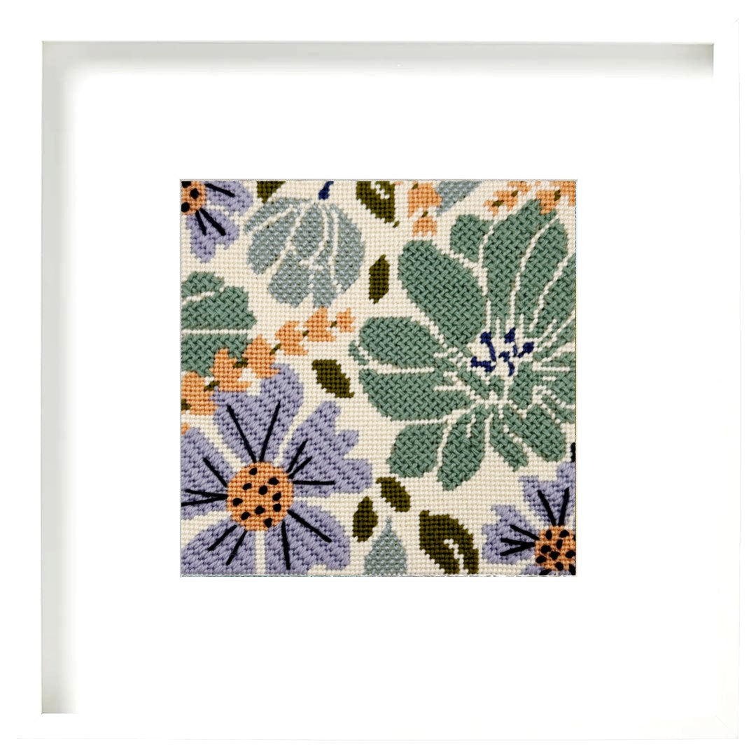 Floral needlepoint pattern with green, purple, and orange flowers on a beige background