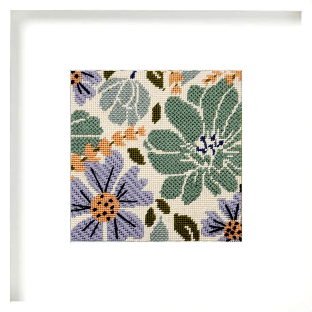 Floral needlepoint pattern with green, purple, and orange flowers on a beige background