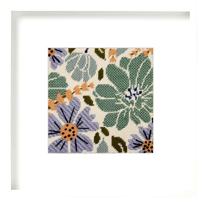 Floral needlepoint pattern with green, purple, and orange flowers on a beige background