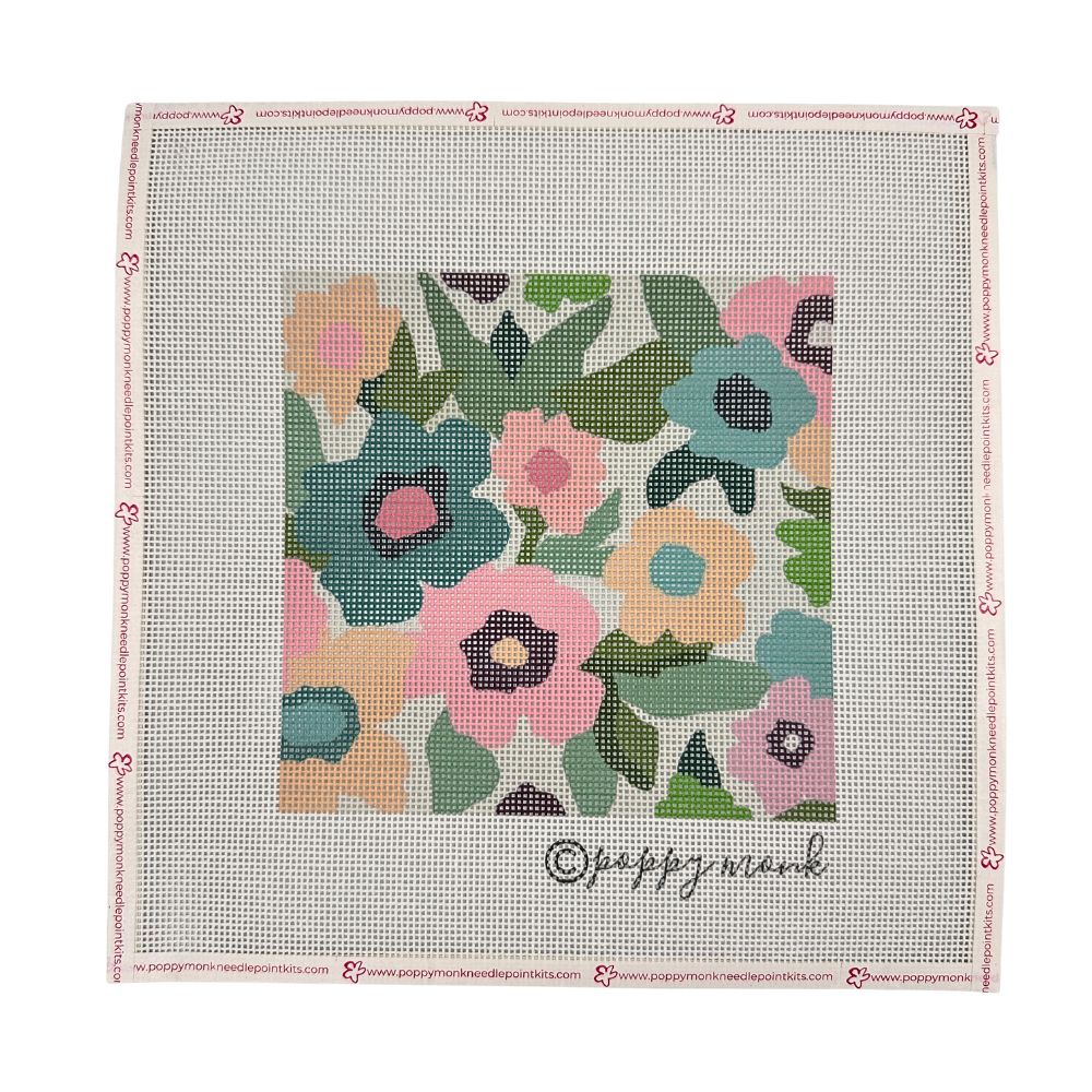 A square needlepoint canvas featuring a colorful floral pattern in the center, surrounded by a light pink border with small flower motifs and the brand name &