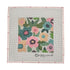 A square needlepoint canvas featuring a colorful floral pattern in the center, surrounded by a light pink border with small flower motifs and the brand name &