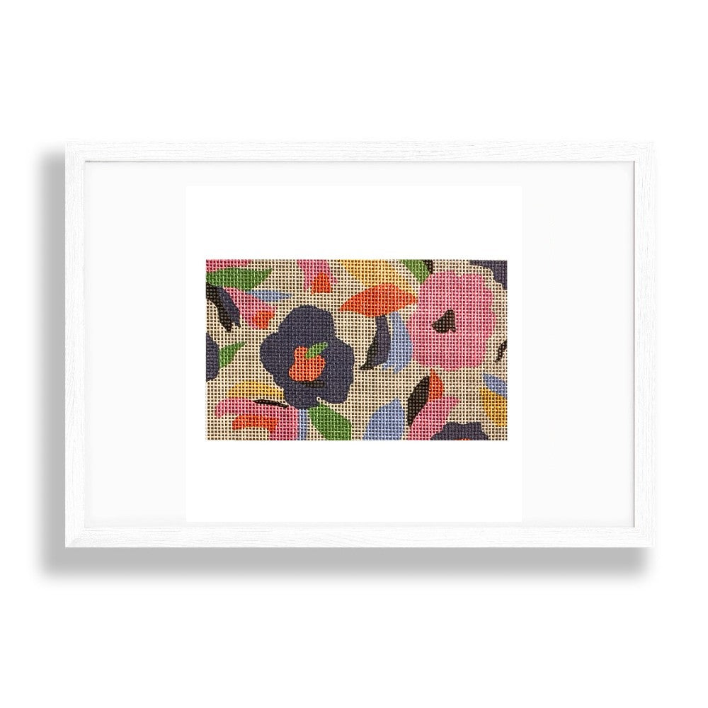Framed needlepoint artwork with colorful floral pattern