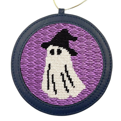 A halloween needlepoint ornament of a ghost dressed up as a witch