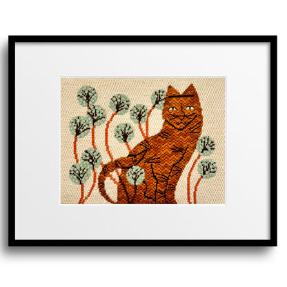 Ginger tabby cat needlepoint design with decorative stitches presented in a black frame