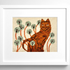 Framed needlepoint of a ginger tabby cat