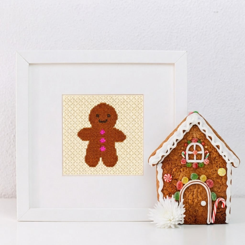 Gingerbread man needlepoint design in a white frame