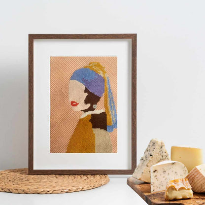 Girl With A Pearl Earring needlepoint design shown in a frame.