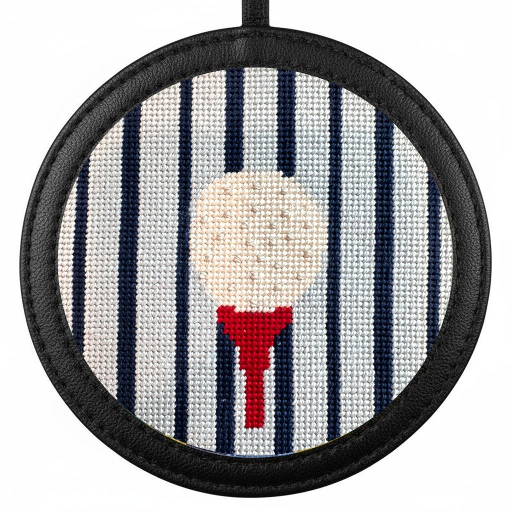 gold ball on a tee needlepoint ornament in a black frame