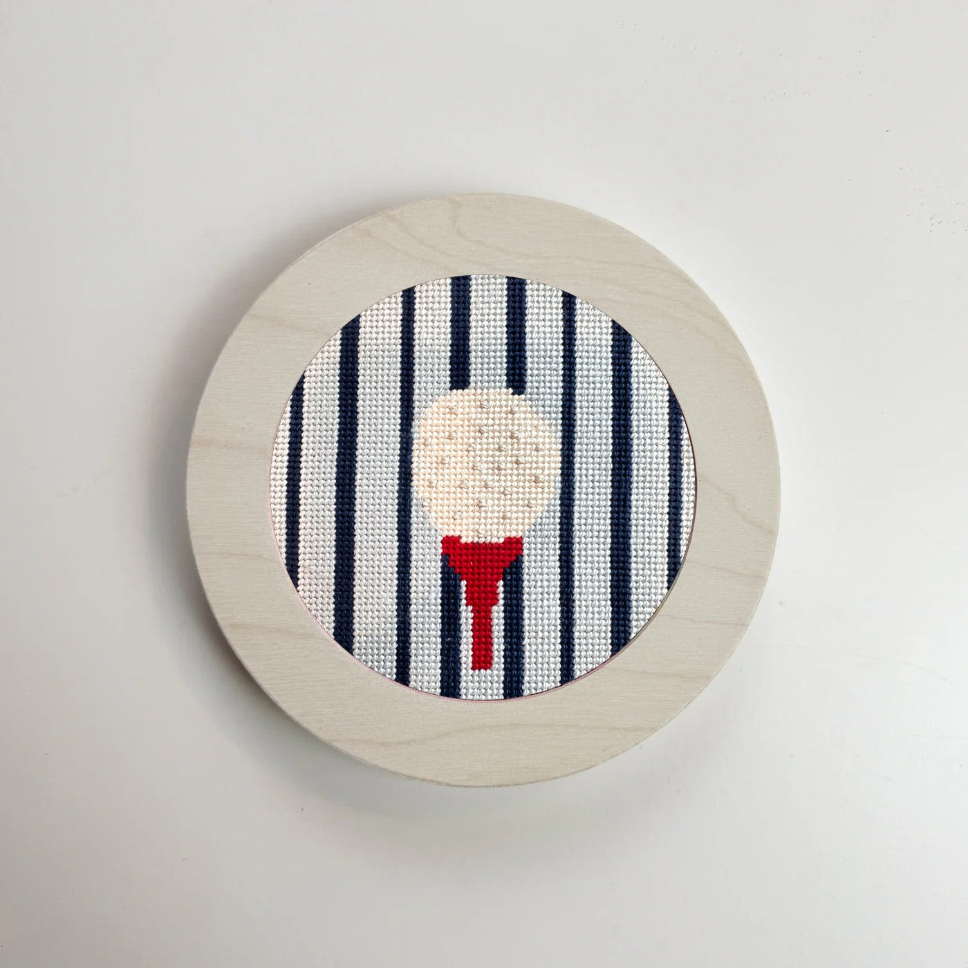 gold ball on a tee needlepoint ornament in a white frame