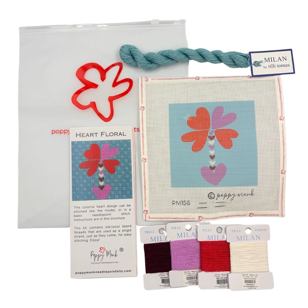 Valetines needlepoint kit with floral design, thread packages, and Milan brand tag on a white background