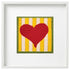 Framed needlepoint heart with yellow and white striped background