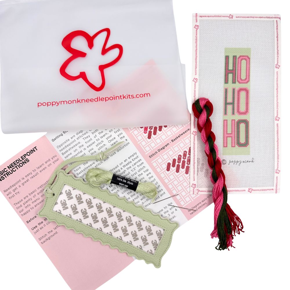 A needlepoint kit of a Ho Ho Ho design with threads and instructions