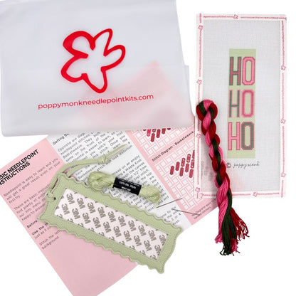 A needlepoint kit of a Ho Ho Ho design with threads and instructions