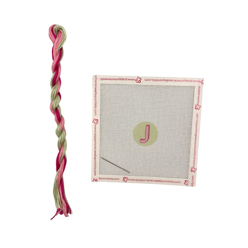 Cross-stitch kit with pre-printed pattern and colored yarn on a white background