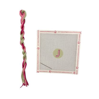 Cross-stitch kit with pre-printed pattern and colored yarn on a white background