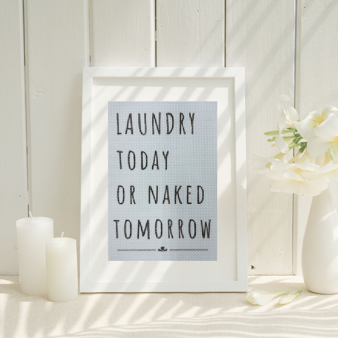 A funny needlepoint sign for the laundry.