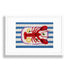 A framed needlepoint featuring a red lobster on a blue and white striped background, enclosed in a white frame against a white wall.