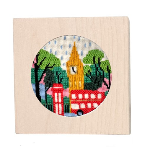 London needlepoint kit in a white-washed wooden frame