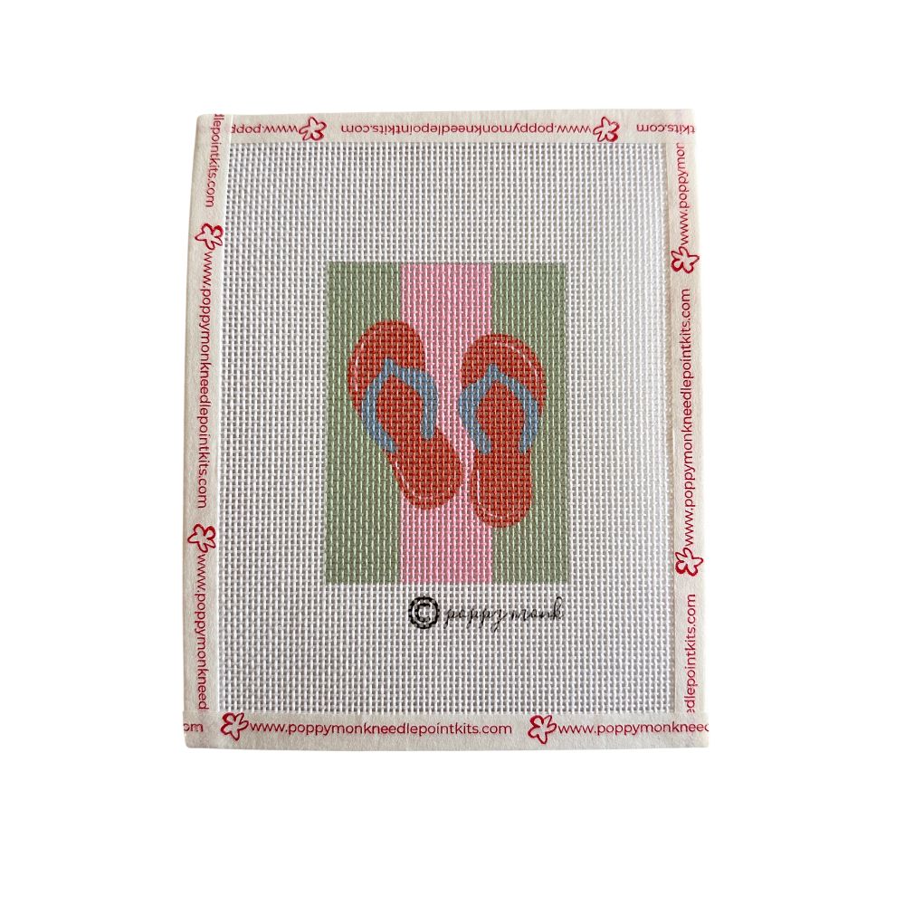 Needlepoint canvas with a design of red flip-flops on a pink background, framed by Poppy Murnen&