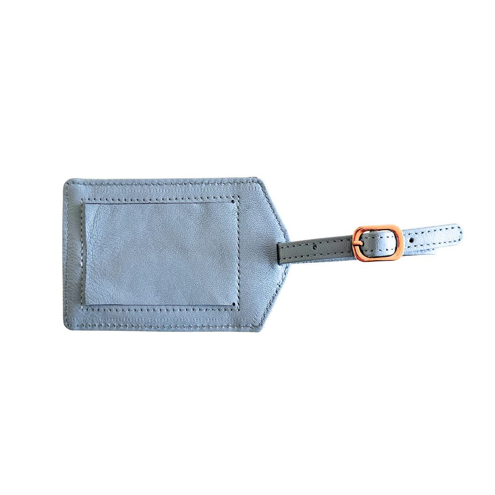 Light blue leather luggage tag with a gold buckle on a white background