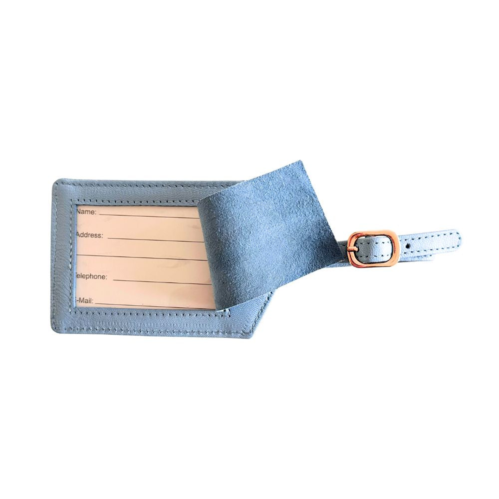Blue leather luggage tag with wooden insert on a white background