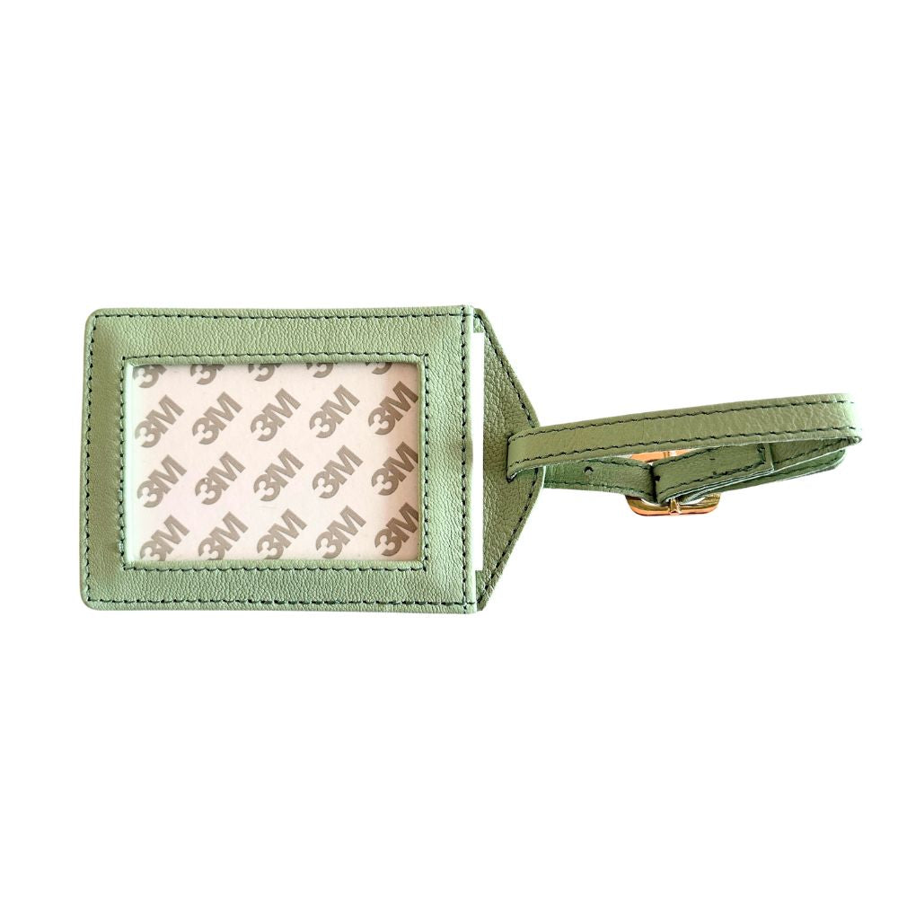 Green luggage tag with a reflective surface on a white background
