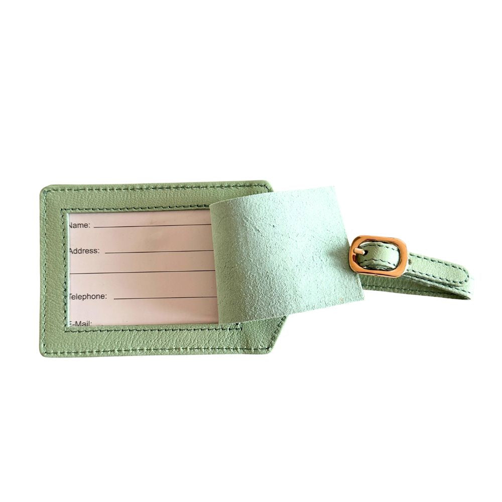 Green fabric luggage tag with a brown buckle on a white background