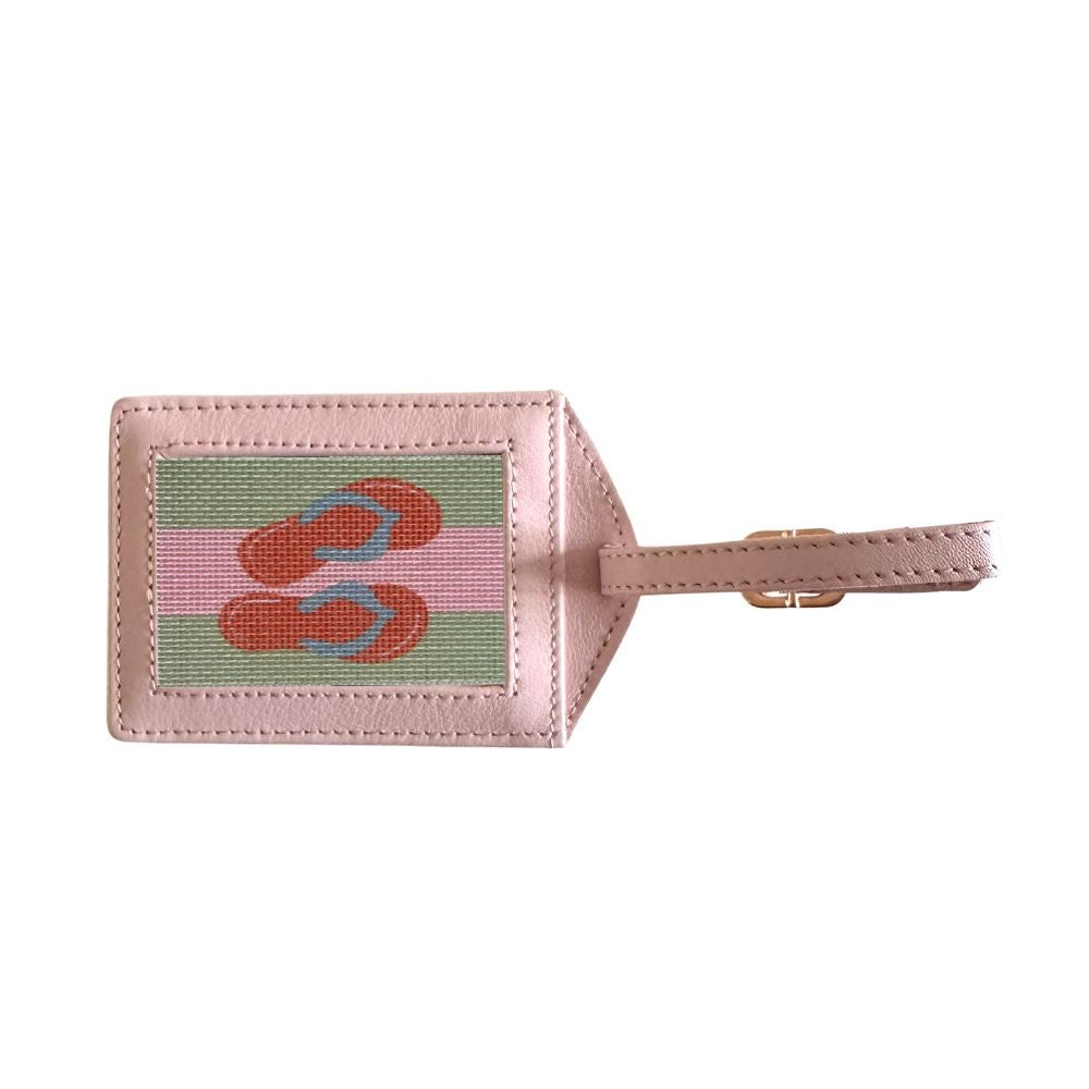 Luggage tag with flip-flop design on a pink background