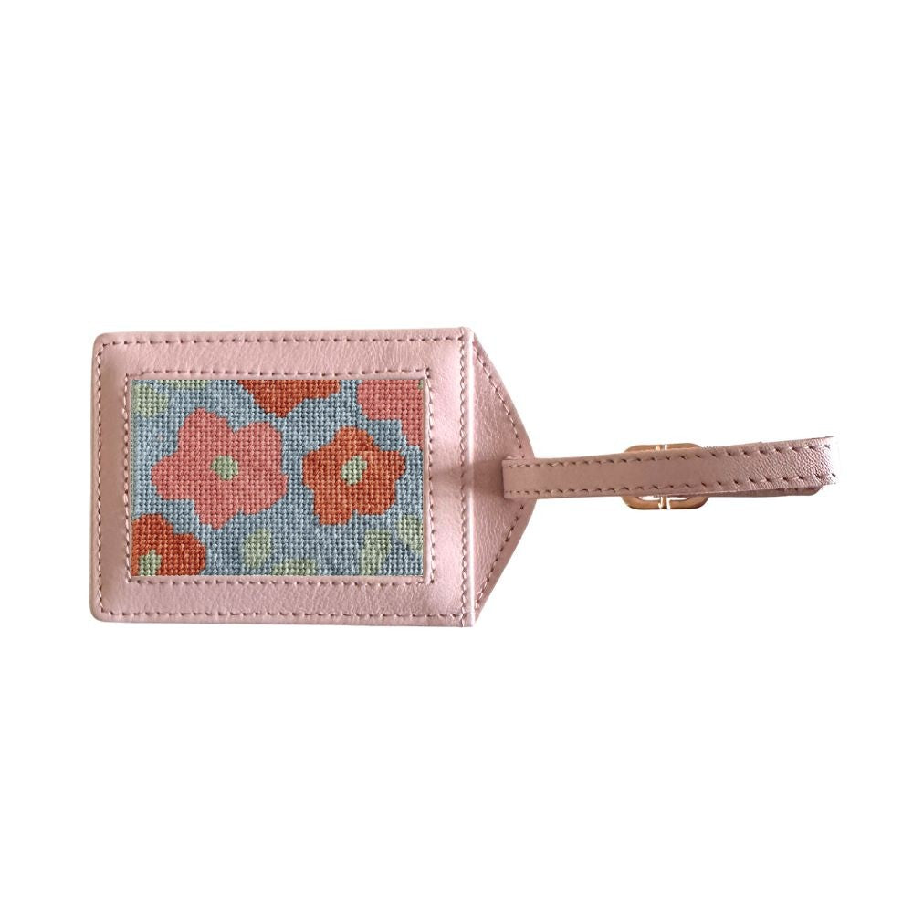 Luggage tag with floral design on a pink background