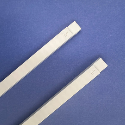 Two white plastic stretcher bars 9 inches