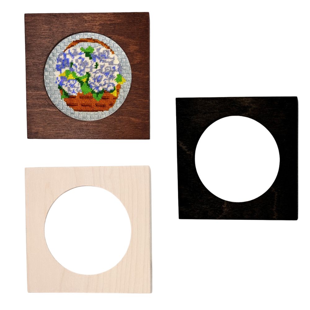 Set of three wooden picture frames with different finishes on a white background