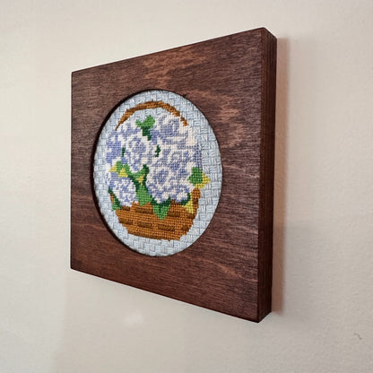 frame for needlepoint ornament on a wall