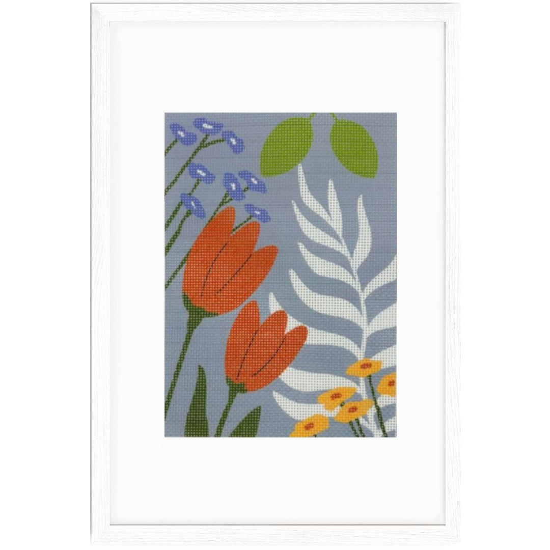 Framed needlepoint artwork with colorful floral design on a blue background