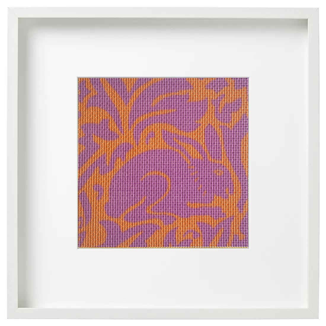 Morris rabbit needlepoint in pink and orange in a frame